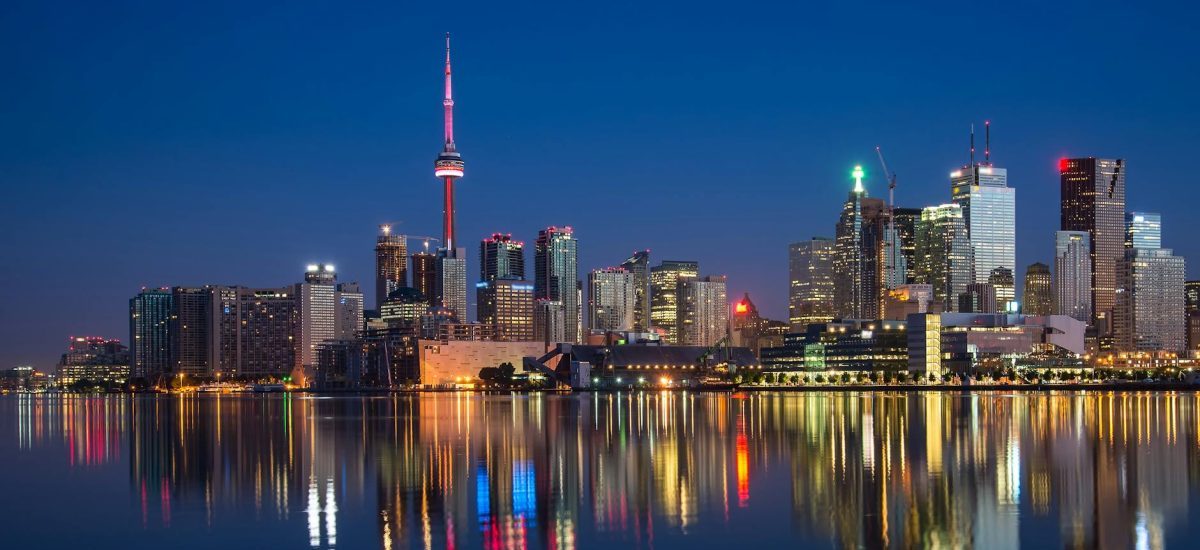 buildings near body of water at night